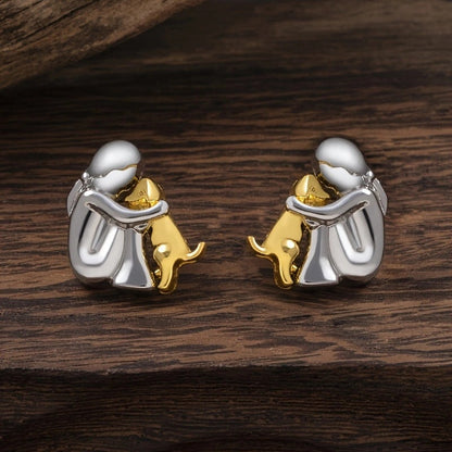 A little girl and a dog embrace earrings